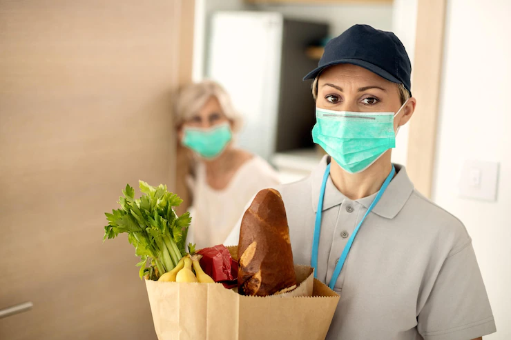 female-courier-with-face-mask-doing-home-delivery-during-covid19-epidemic_637285-8476